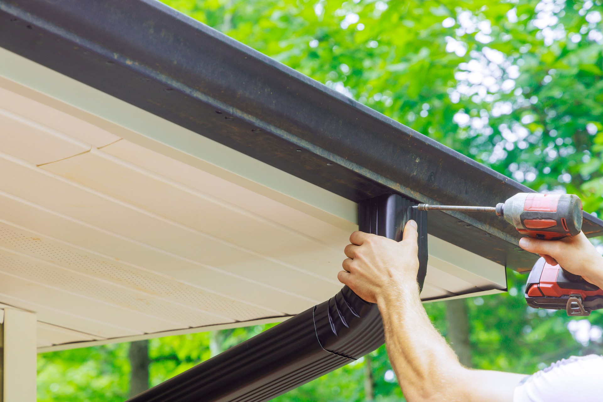 Assembling installing gutter channels on roof of a home